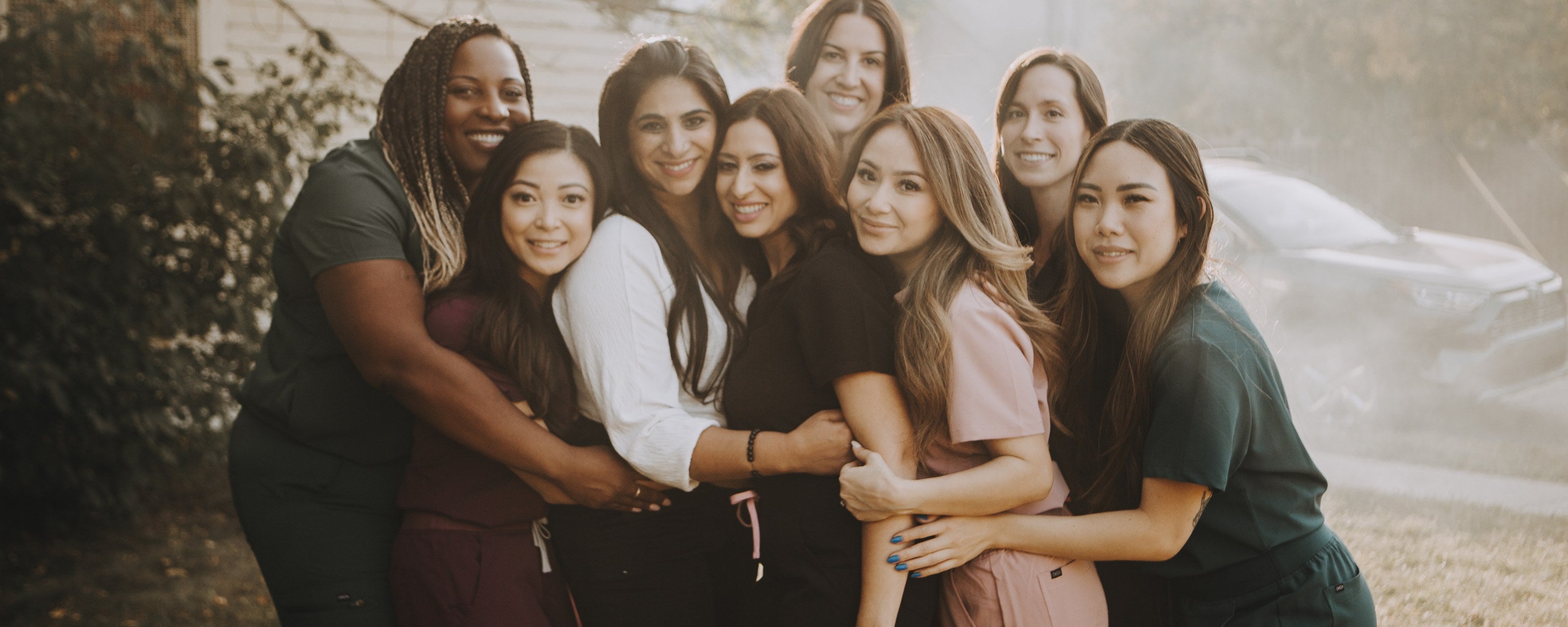 KOA team in scrubs - tops and joggers in maroon, black, blush and forest