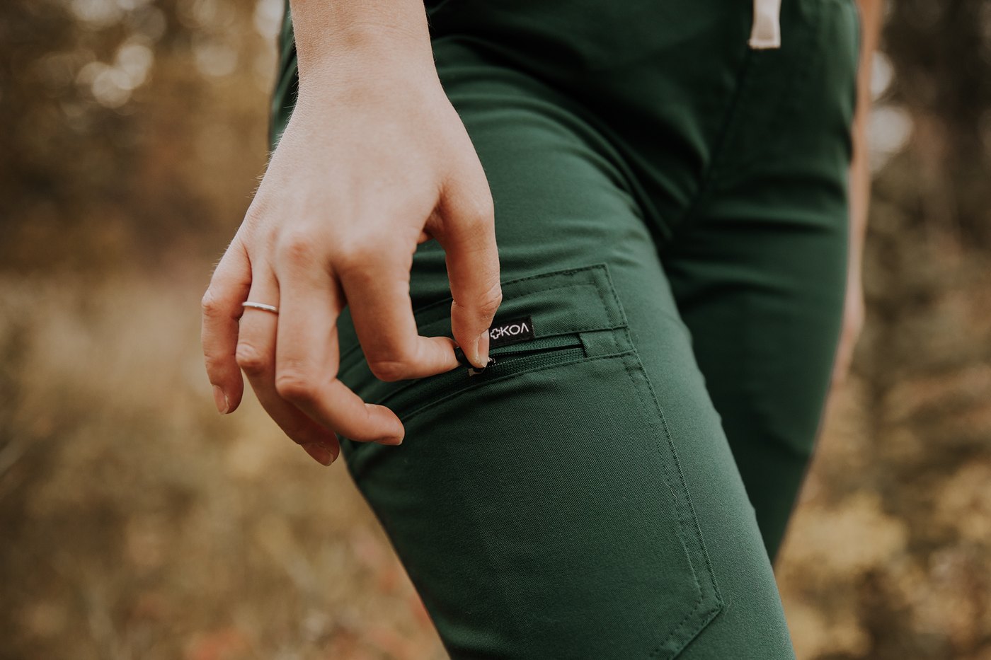 Topstitched cargo pocket on forest green KOA scrub joggers