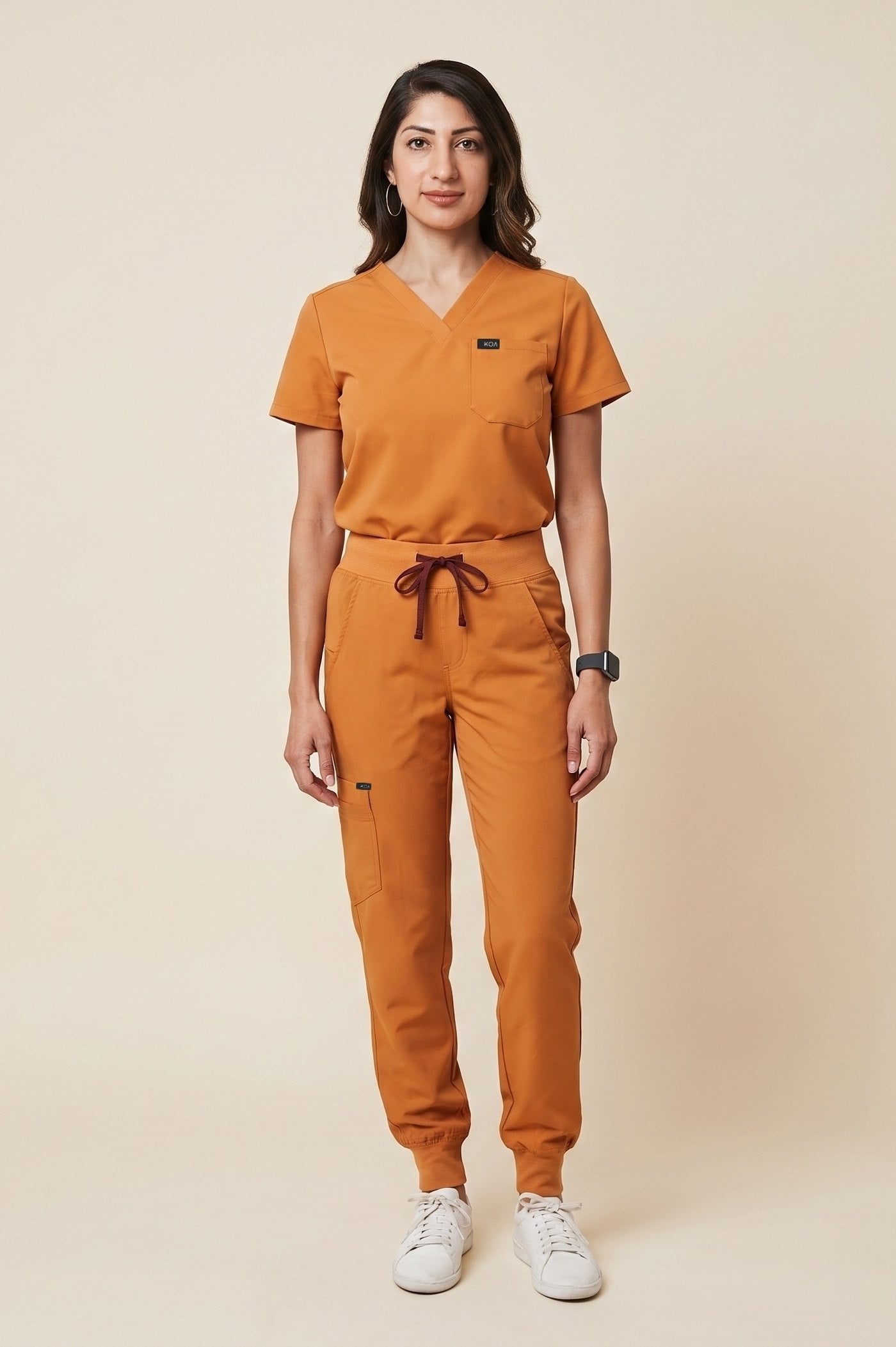 Turmeric KOA scrub set, showing the jogger drawstring and cargo pocket